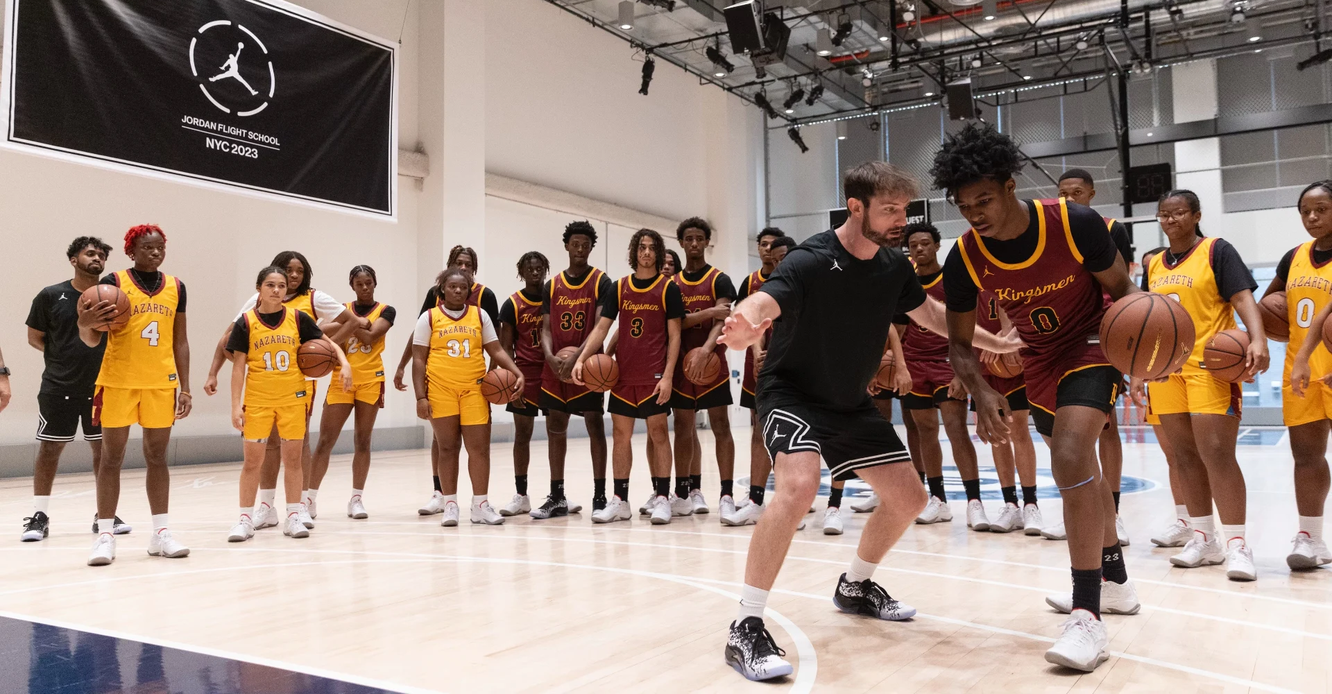 Drew Hanlen coaching at a basketball clinic